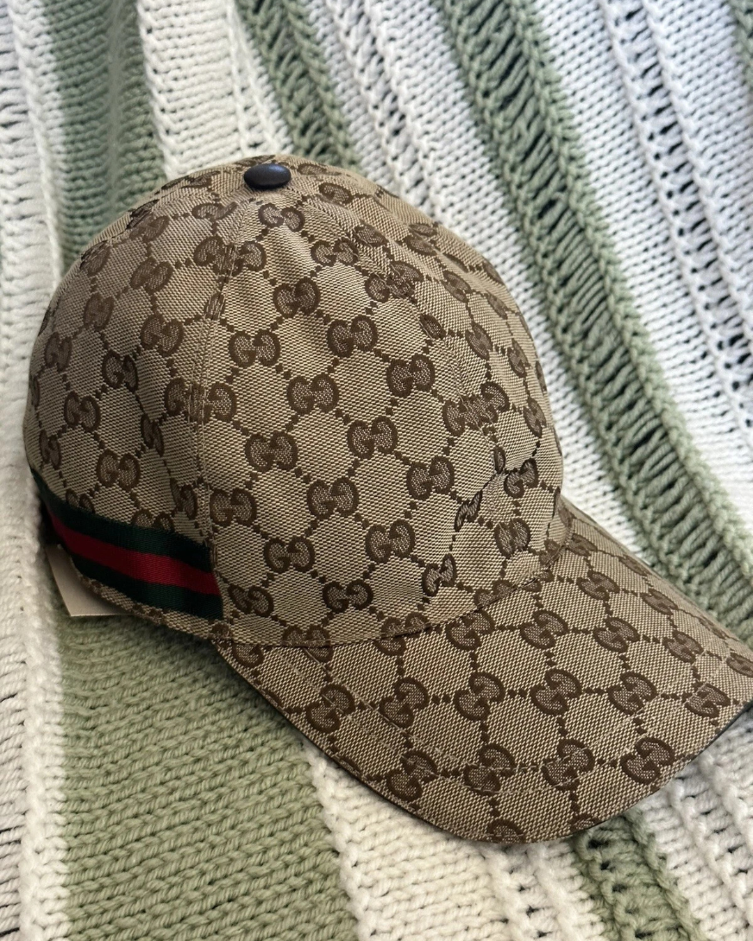 Gucci GG Supreme Canvas unisex baseball cap with adjustable strap and classic logo design, luxury designer headwear.