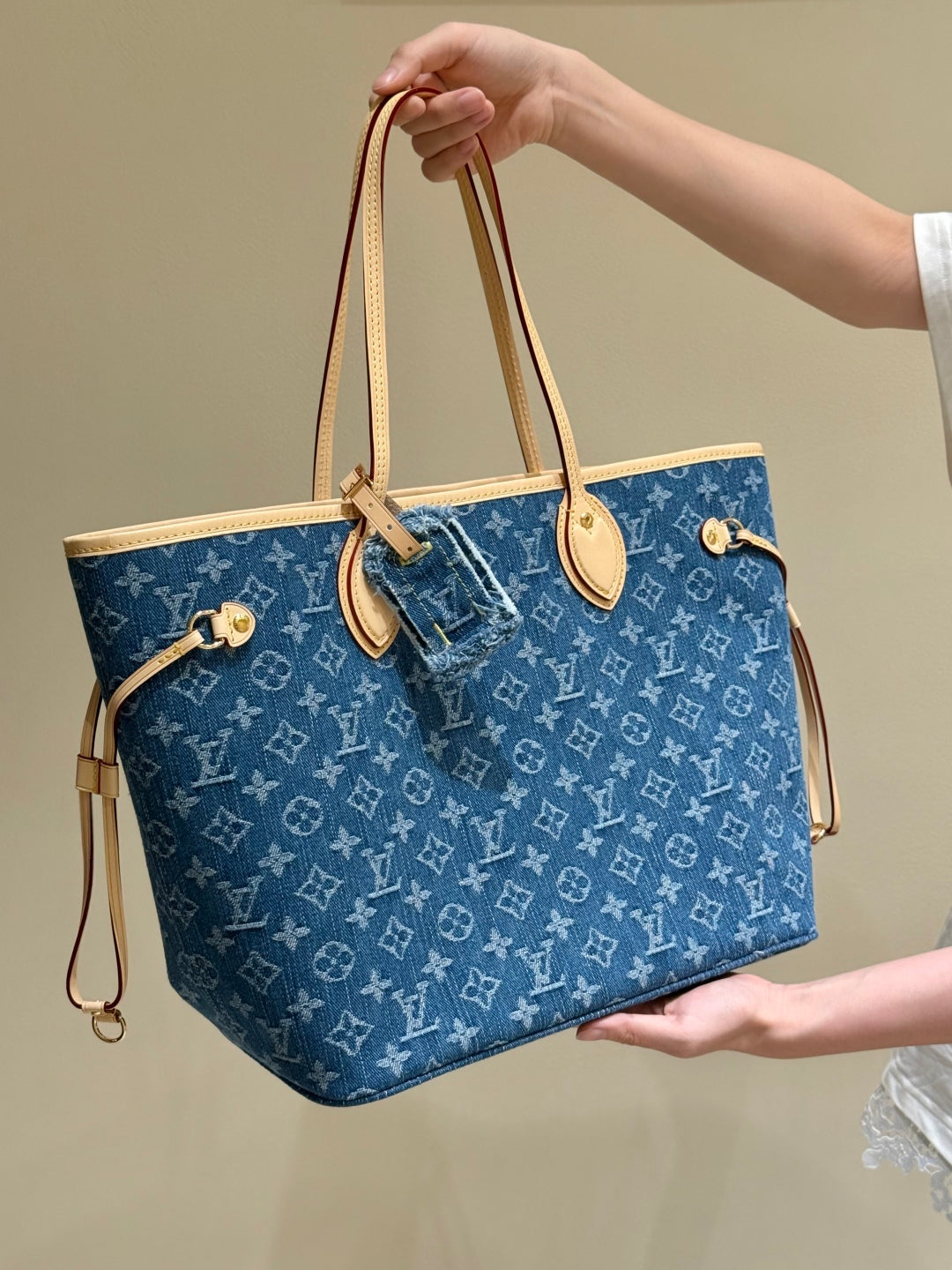 Louis Vuitton Denim Monogram Neverfull tote bag with leather handles and spacious interior, luxury designer handbag by Luxivio
