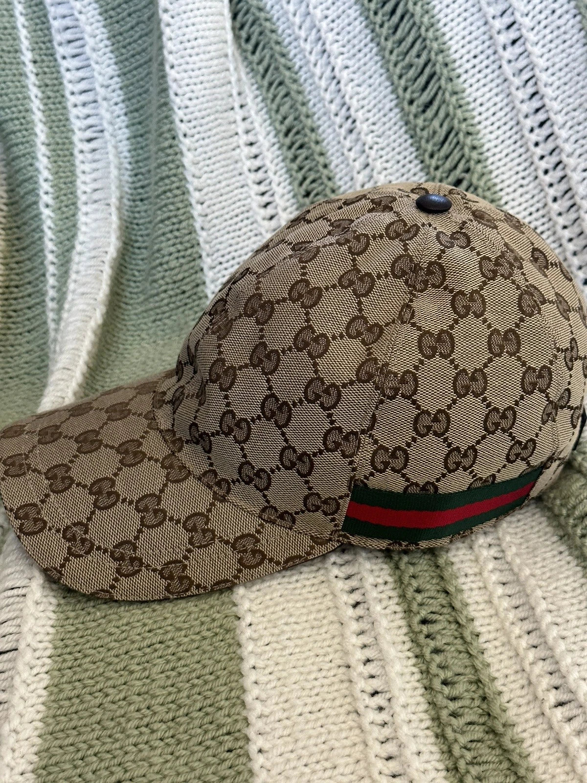 Gucci GG Supreme Canvas baseball cap, luxury designer unisex hat with classic logo, casual style, and adjustable strap.