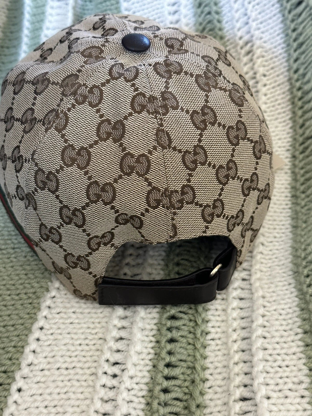 Gucci GG Supreme canvas baseball cap, luxury unisex designer hat with iconic pattern and adjustable strap.